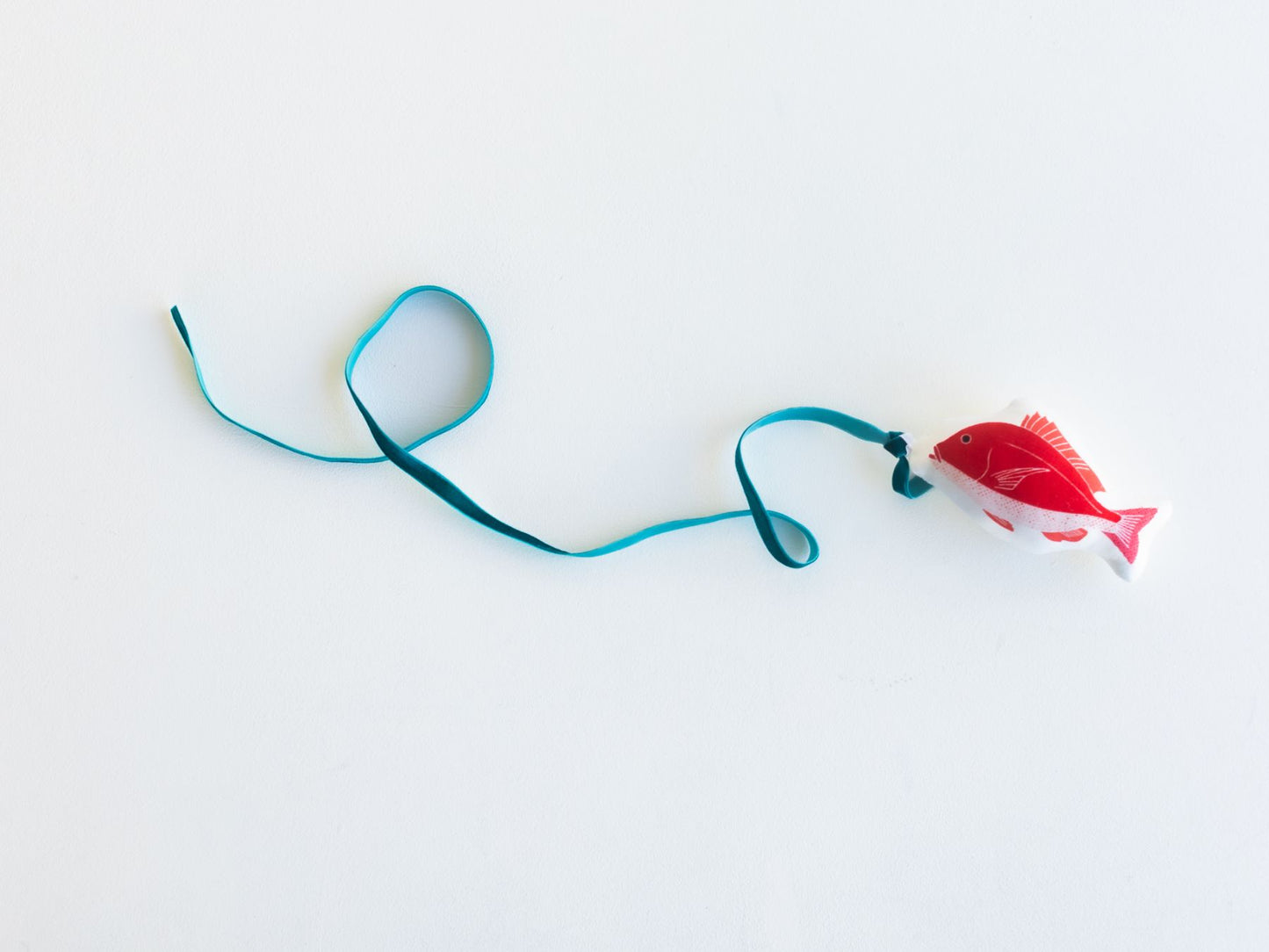 鯛のクッショントイはループ付きなので、ベロアリボンをくくりつければ、おめでたい猫じゃらしに！